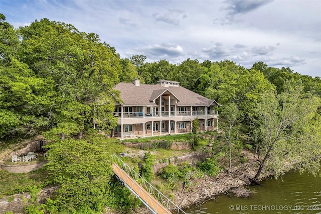 32290 S 630th Rd, Jay, OK 74346 - back of house featuring a chimney, a shingled roof, a water view, and a wooded view