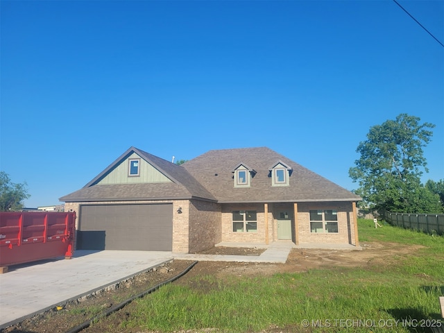 14474 N 50th W Ave, Skiatook, OK 74070 - view of front of home with brick siding, driveway, fence, and an attached garage