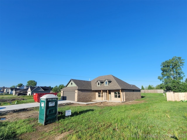 14474 N 50th W Ave, Skiatook, OK 74070 - view of front of property featuring a garage, brick siding, and concrete driveway