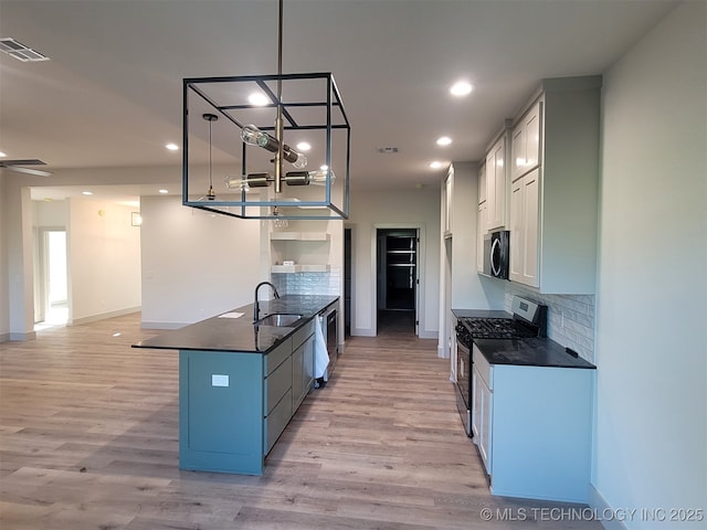 14474 N 50th W Ave, Skiatook, OK 74070 - kitchen with stainless steel appliances, a sink, a peninsula, tasteful backsplash, and recessed lighting