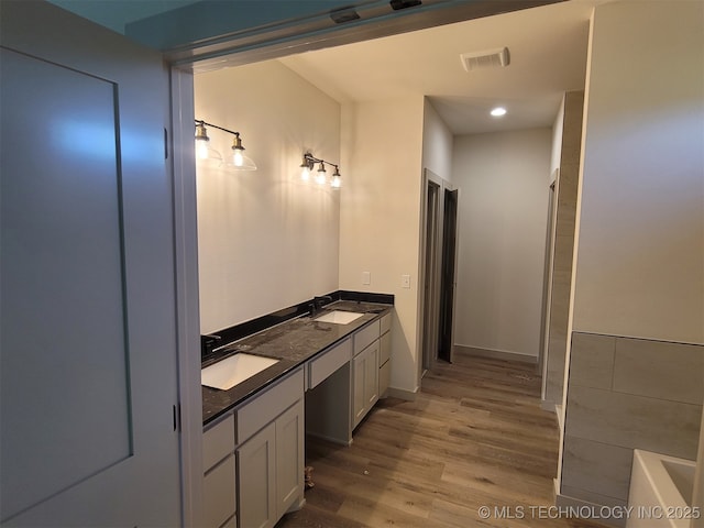 14474 N 50th W Ave, Skiatook, OK 74070 - bathroom featuring wood finished floors, double vanity, and baseboards