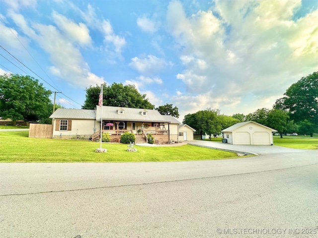 809 N K St, Quinton, OK 74561 - view of front of property featuring a garage, covered porch, an outdoor structure, metal roof, and a front lawn