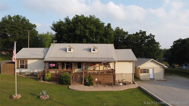 809 N K St, Quinton, OK 74561 - view of front of home featuring covered porch, a front lawn, stairway, and metal roof