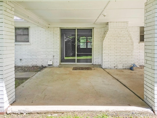 5854 E 46th Pl, Tulsa, OK 74135 - property entrance with brick siding and a patio area