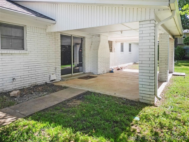 5854 E 46th Pl, Tulsa, OK 74135 - doorway to property with brick siding, a patio, and roof with shingles