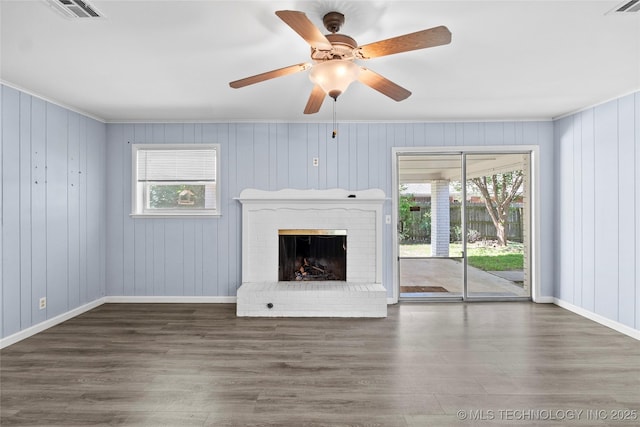 5854 E 46th Pl, Tulsa, OK 74135 - unfurnished living room with plenty of natural light, wood finished floors, ornamental molding, and a brick fireplace