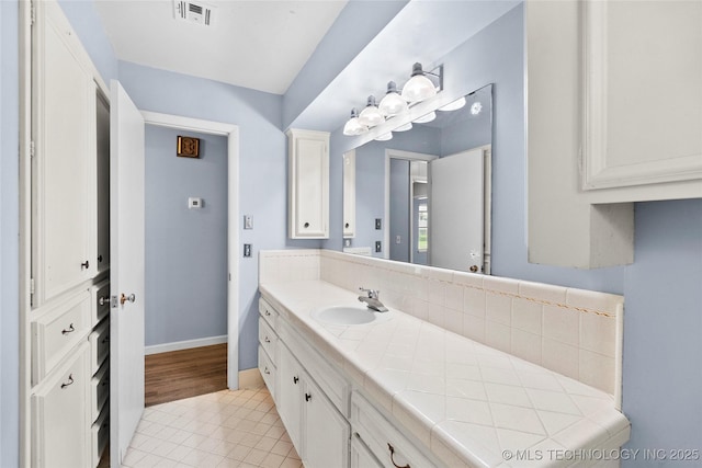 5854 E 46th Pl, Tulsa, OK 74135 - bathroom with tile patterned floors, vanity, and baseboards