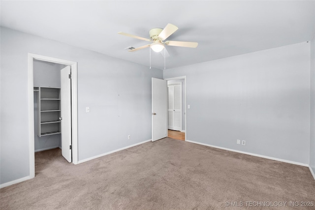5854 E 46th Pl, Tulsa, OK 74135 - unfurnished bedroom featuring carpet flooring, a walk in closet, and baseboards