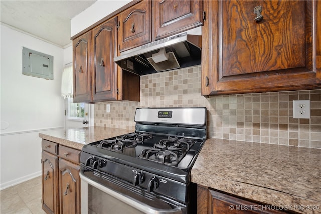 kitchen featuring stainless steel range with gas stovetop, under cabinet range hood, electric panel, and decorative backsplash