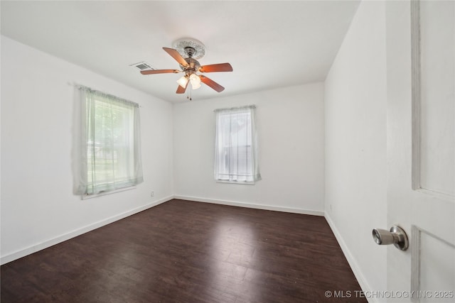 unfurnished room featuring healthy amount of natural light, ceiling fan, wood finished floors, and baseboards