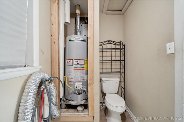 bathroom featuring water heater, toilet, and baseboards