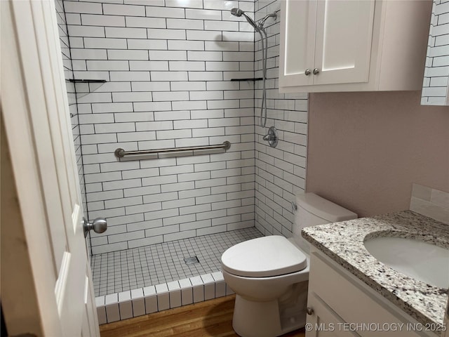 1509 Pawnee Ave, Hartshorne, OK 74547 - full bath featuring vanity, a stall shower, toilet, and wood finished floors