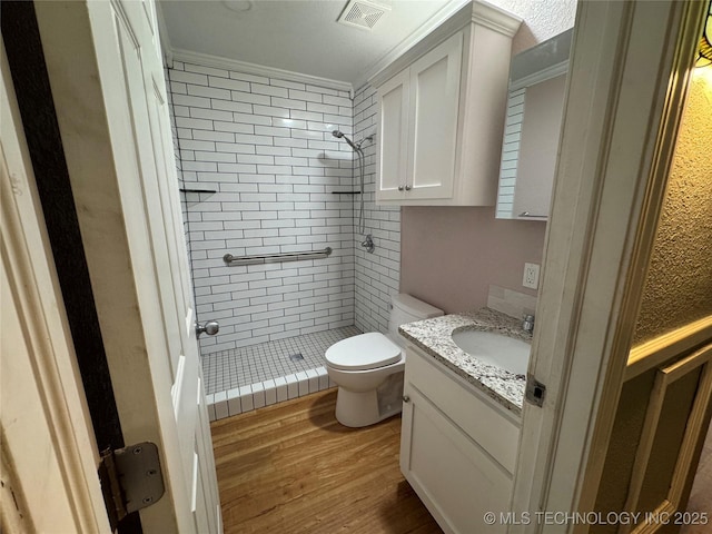 1509 Pawnee Ave, Hartshorne, OK 74547 - full bath featuring ornamental molding, a stall shower, toilet, vanity, and wood finished floors
