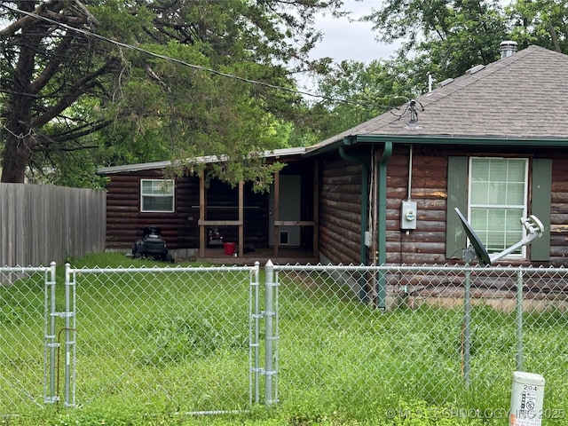 1509 Pawnee Ave, Hartshorne, OK 74547 - log cabin with log veneer siding, a gate, and roof with shingles