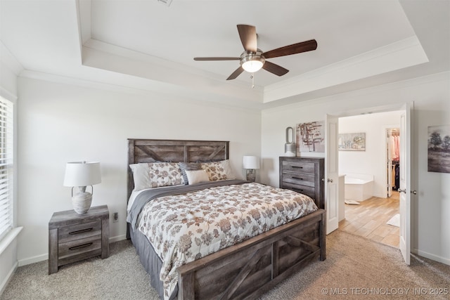 bedroom with a raised ceiling, carpet flooring, ornamental molding, ceiling fan, and baseboards