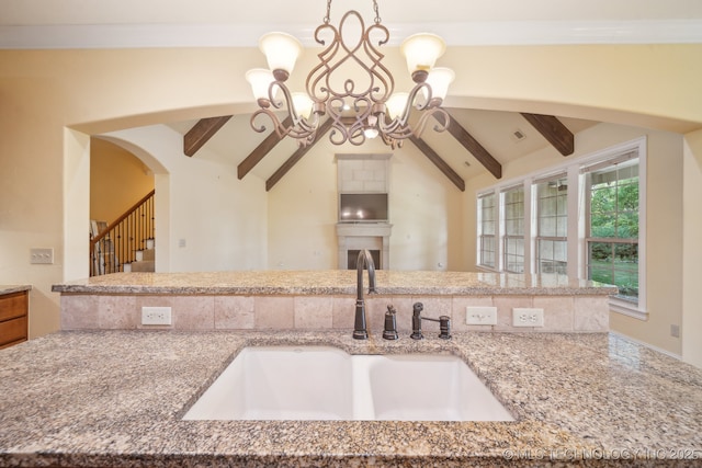 7287 E 111th Pl, Bixby, OK 74008 - kitchen featuring a sink, open floor plan, a chandelier, light stone countertops, and hanging light fixtures