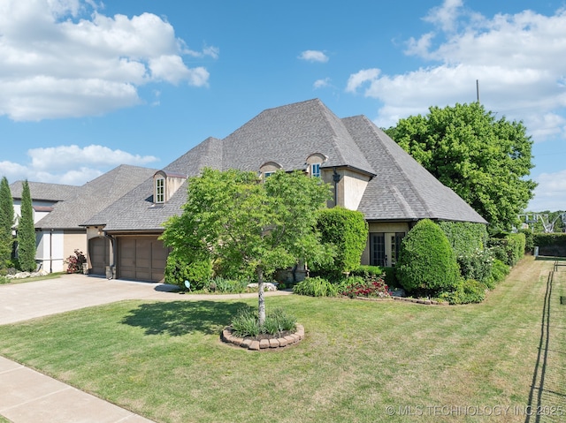7287 E 111th Pl, Bixby, OK 74008 - french provincial home with an attached garage, driveway, and a front lawn