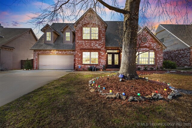 5446 E 88th St, Tulsa, OK 74137 - traditional home featuring brick siding, french doors, concrete driveway, an attached garage, and a shingled roof