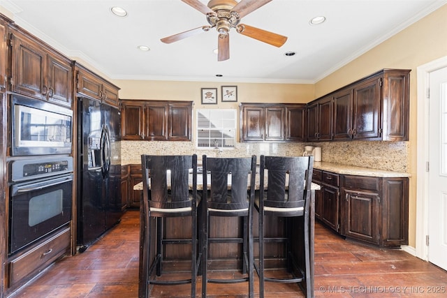 5446 E 88th St, Tulsa, OK 74137 - kitchen with black appliances, dark wood-style flooring, a center island, dark brown cabinetry, and recessed lighting