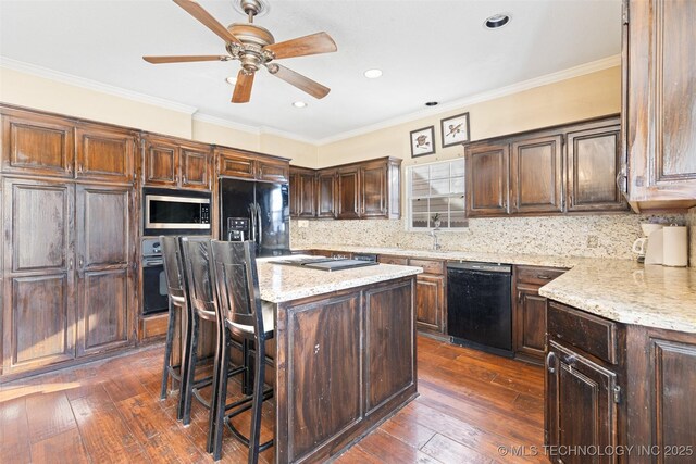 5446 E 88th St, Tulsa, OK 74137 - kitchen featuring black appliances, a center island, dark wood-style flooring, a kitchen breakfast bar, and light stone countertops