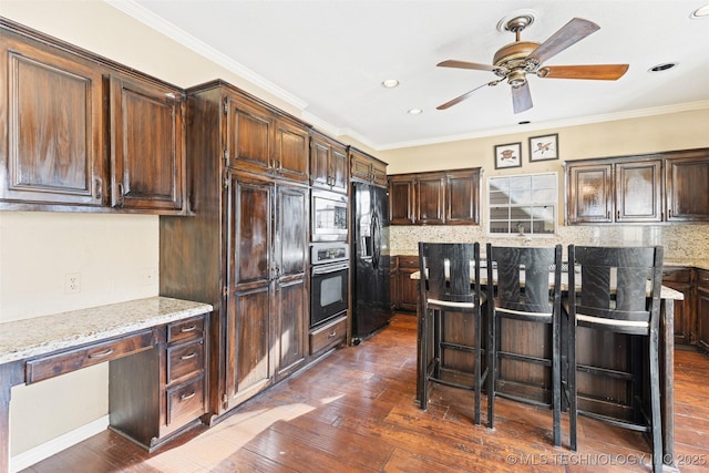 5446 E 88th St, Tulsa, OK 74137 - kitchen featuring wall oven, stainless steel microwave, black refrigerator with ice dispenser, dark wood finished floors, and tasteful backsplash