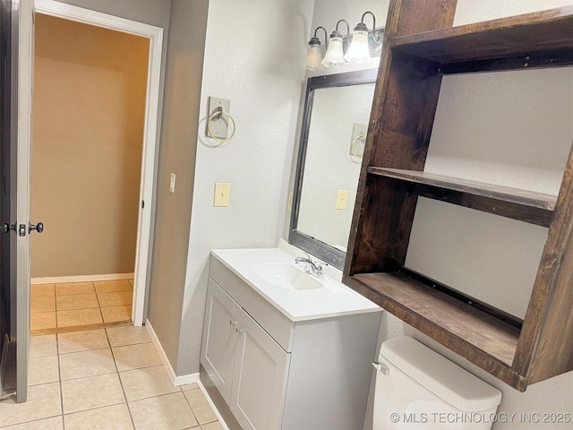 half bath with tile patterned floors, baseboards, toilet, and vanity