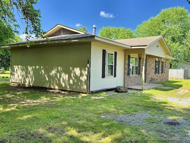 view of side of property featuring brick siding