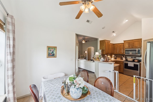 29901 E 137th Pl, Coweta, OK 74429 - dining space with ceiling fan, light tile patterned floors, arched walkways, high vaulted ceiling, and recessed lighting