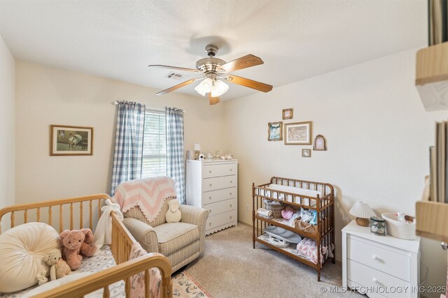 29901 E 137th Pl, Coweta, OK 74429 - bedroom featuring light carpet, ceiling fan, and a crib