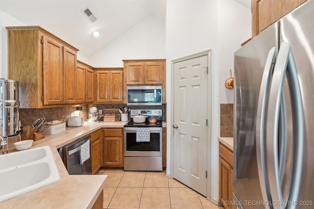 29901 E 137th Pl, Coweta, OK 74429 - kitchen with appliances with stainless steel finishes, a sink, vaulted ceiling, decorative backsplash, and light countertops