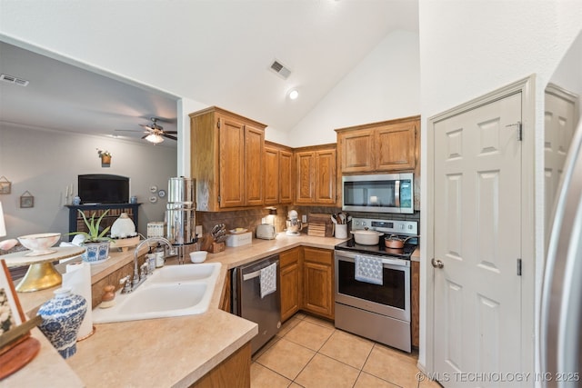 29901 E 137th Pl, Coweta, OK 74429 - kitchen with appliances with stainless steel finishes, a sink, a ceiling fan, tasteful backsplash, and light countertops