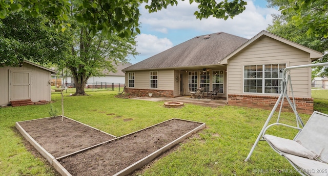 29901 E 137th Pl, Coweta, OK 74429 - back of house with brick siding, a fire pit, a garden, a shingled roof, and a patio