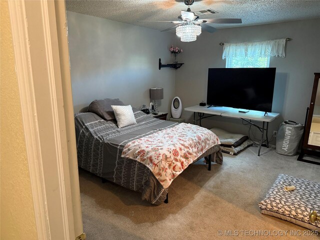 carpeted bedroom with a textured ceiling and a ceiling fan