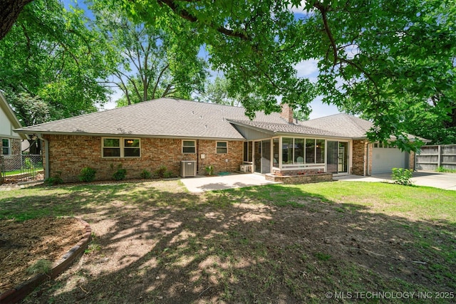 6123 E 53rd St, Tulsa, OK 74135 - view of front of home featuring a sunroom, a garage, brick siding, concrete driveway, and a chimney
