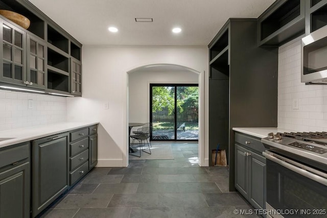 4907 S Boston Ave, Tulsa, OK 74105 - kitchen featuring open shelves, stainless steel appliances, arched walkways, backsplash, and recessed lighting