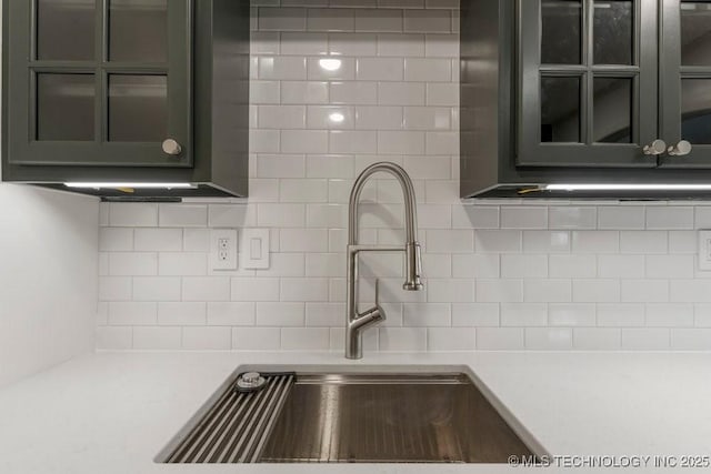 4907 S Boston Ave, Tulsa, OK 74105 - kitchen featuring a sink, tasteful backsplash, and light countertops