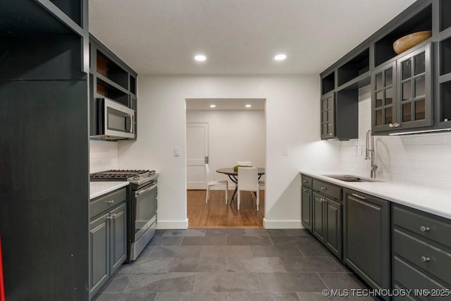 4907 S Boston Ave, Tulsa, OK 74105 - kitchen featuring appliances with stainless steel finishes, open shelves, a sink, backsplash, and recessed lighting
