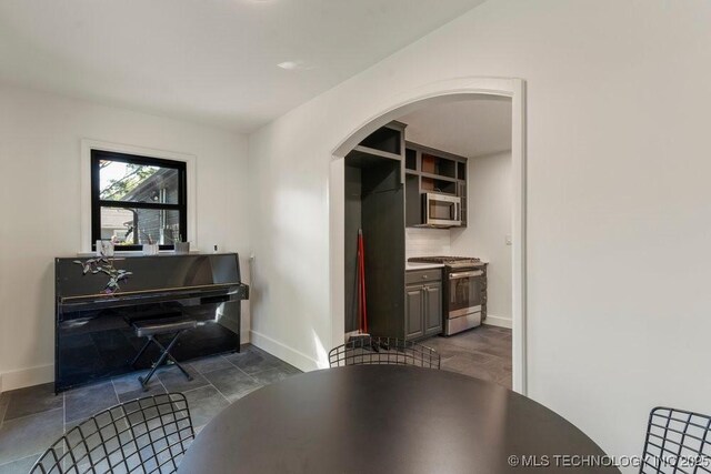 4907 S Boston Ave, Tulsa, OK 74105 - dining space featuring arched walkways and baseboards