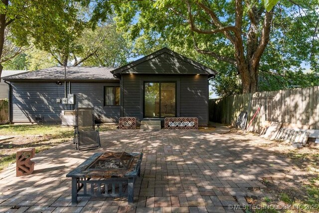 4907 S Boston Ave, Tulsa, OK 74105 - rear view of house featuring a fire pit, a patio, and fence