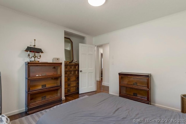 4907 S Boston Ave, Tulsa, OK 74105 - bedroom featuring ornamental molding, wood finished floors, and baseboards