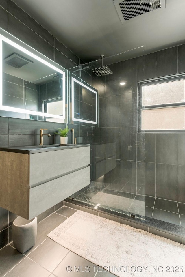 4907 S Boston Ave, Tulsa, OK 74105 - bathroom with tiled shower, vanity, and tile patterned flooring