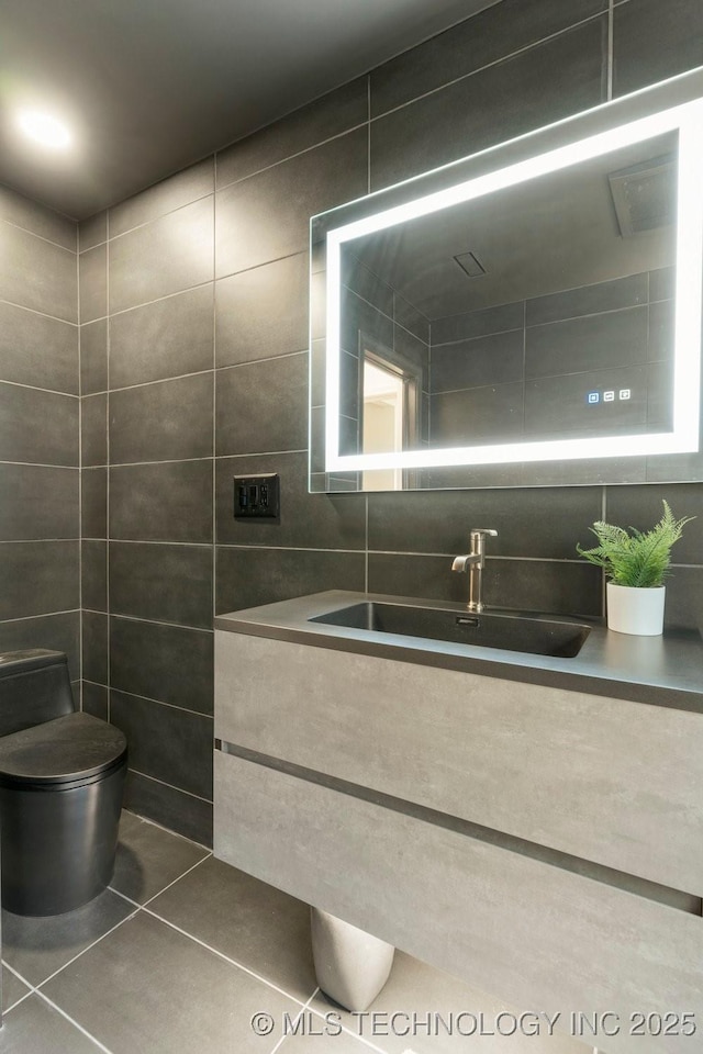 4907 S Boston Ave, Tulsa, OK 74105 - bathroom with tile walls, vanity, and tile patterned floors