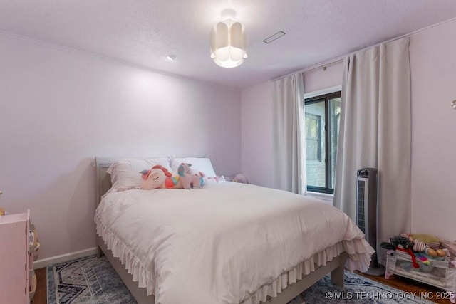 4907 S Boston Ave, Tulsa, OK 74105 - bedroom featuring a textured ceiling, ornamental molding, and radiator heating unit