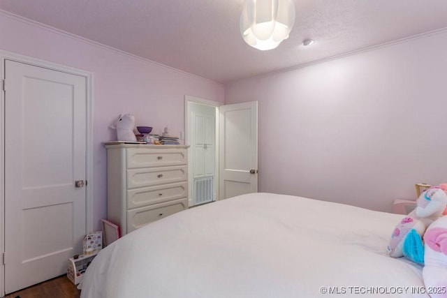 4907 S Boston Ave, Tulsa, OK 74105 - bedroom with ornamental molding and wood finished floors