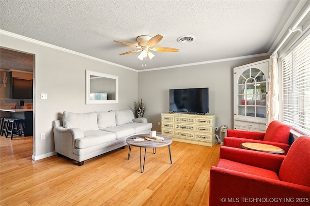 300 Michele, Calera, OK 74730 - living area with a ceiling fan, wood finished floors, crown molding, and a textured ceiling