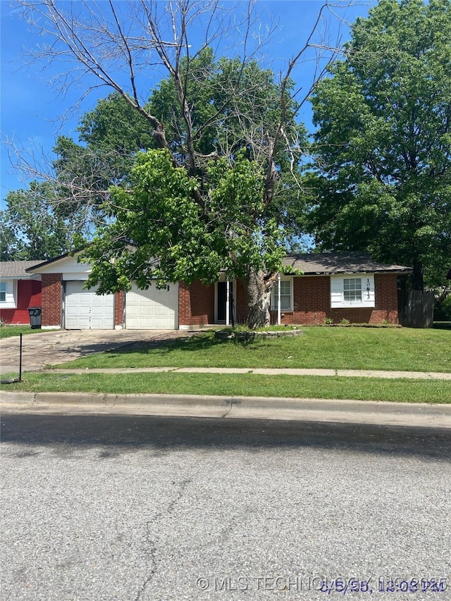 10813 E 34th Pl, Tulsa, OK 74146 - view of front of house with brick siding, a front lawn, a garage, and driveway