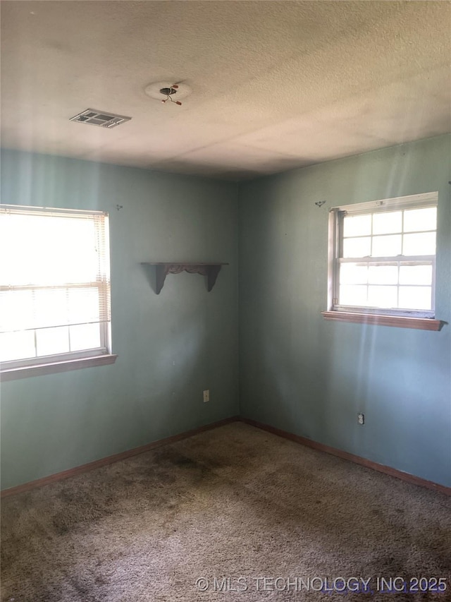 10813 E 34th Pl, Tulsa, OK 74146 - carpeted spare room featuring a textured ceiling and baseboards