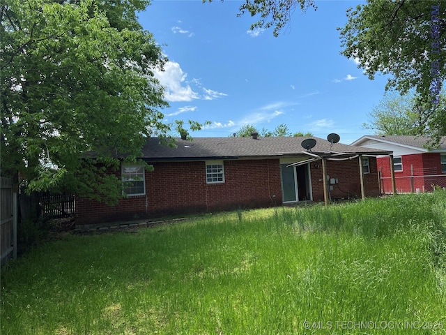 10813 E 34th Pl, Tulsa, OK 74146 - rear view of property featuring fence and brick siding