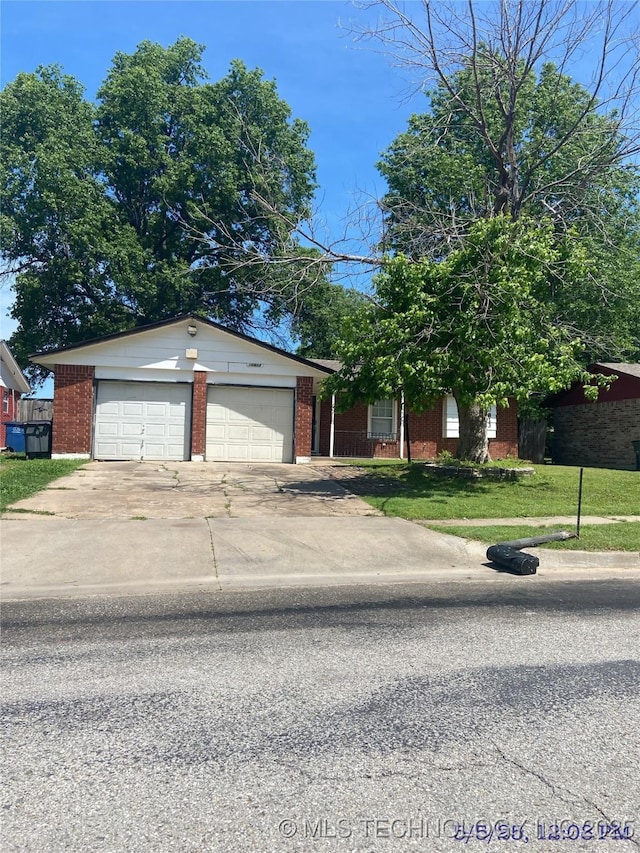 10813 E 34th Pl, Tulsa, OK 74146 - view of front of house with brick siding, concrete driveway, a front yard, and an attached garage