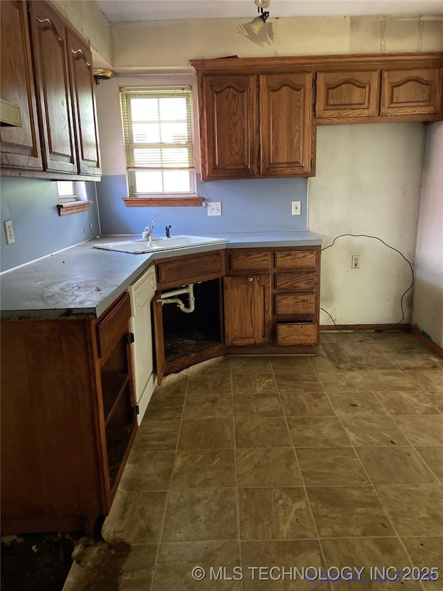 10813 E 34th Pl, Tulsa, OK 74146 - kitchen featuring a sink, white dishwasher, and brown cabinets